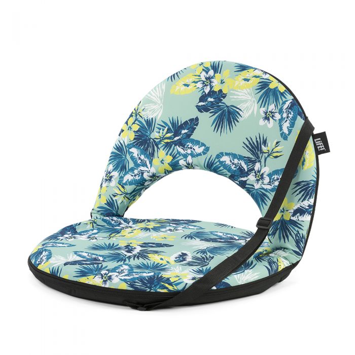 Oblique view of the portable cushion recliner chair in a green and blue tropical floral leave print with carry handle.