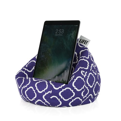 An iPad sits in an iCrib tablet holder rest stand. Its purple with a white geometric print.