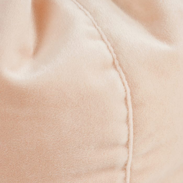A close up of the soft blush colored peach pink velvet material used in the iCrib
