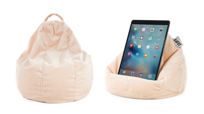 The iCrib is a soft blush peach pink color made from velvet. A tablet, mobile device or iPad rests securely on it. It has a handle and storage pocket.