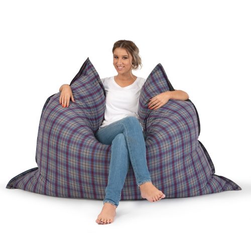 Woman sitting in the arcadia dreams supersize bean bag, purple and grey check