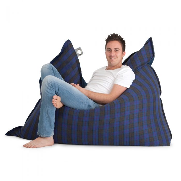 Man reclines in a large supersized arcadia dream bean bag in blue and grey check
