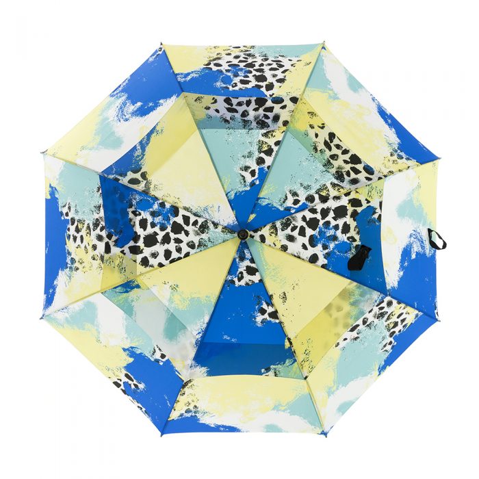 Tier print large golf rain umbrella shown open. The print is green, yellow, white and blue with black splotches. You can see the two layer vent system.