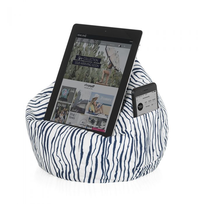 Blue and white marine print iCrib bean caddy shown holding a table and with a mobile phone in the storage pocket