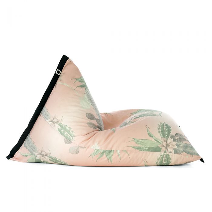 Side view of lifestyle tetrahedral shaped bean bag in pink and green cactus print Kakteen material with black contrast trim