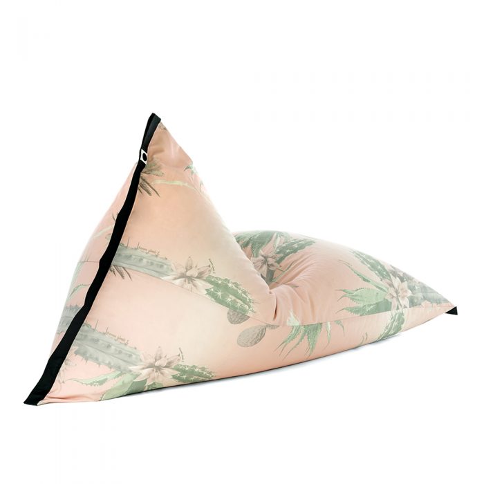 Oblique view of lifestyle tetrahedral shaped bean bag in pink and green cactus print Kakteen material with black contrast trim