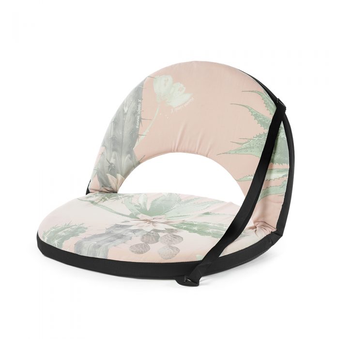 Oblique view of the pink and green kakteen cactus print portable cushion recliner low beach chair seat with black trim and carry strap