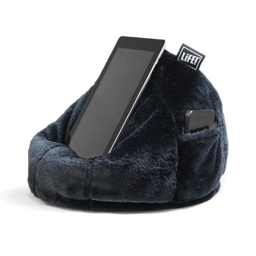 An ipad sits on the black faux fur iCrib tablet holder bean bag with a iPhone visible in the storage pocket