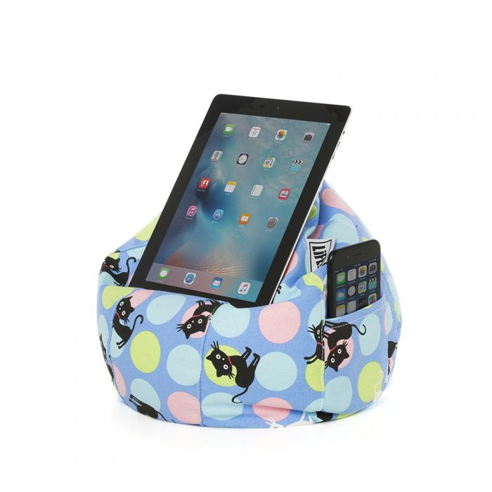Light blue iCrib bean bag with pastel spots and black and white cat print. An iPad or tablet is held in the device for hands free use and a mobile phone or iPhone sits in the storage pocket