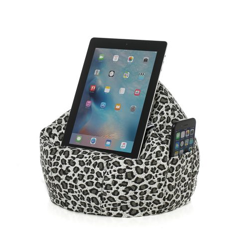 Tan animal print iCrib for resting your iPad, tablet or mobile device on. A phone is visible in the pocket of the faded leopard print iCrib