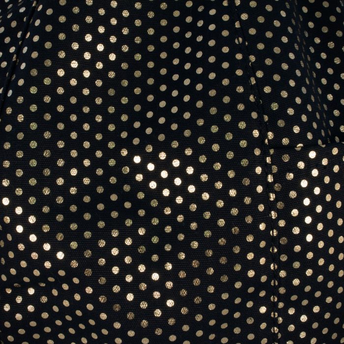 Close up of the small metallic gold dots on black fabric
