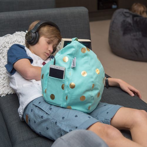 Teen sleeps with headphones on and a book nestled in his powder blue cold coin iCrib tablet bean bag. The bean bag caddy also holds an iphone or ipad in the storage pocket.