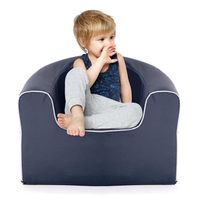 Small child sits on a navy pop armchair foam seat