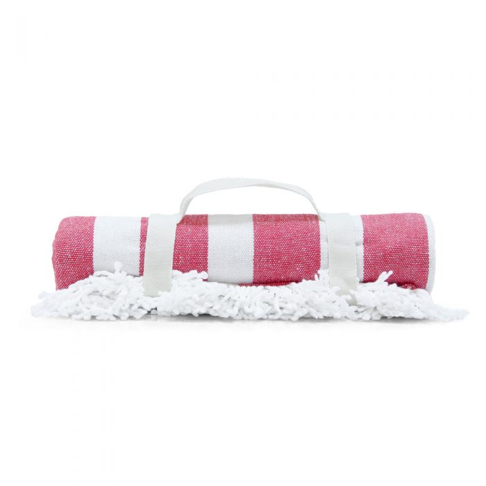 Rolled red stripe beach blanket mat rolled showing handle and fringe