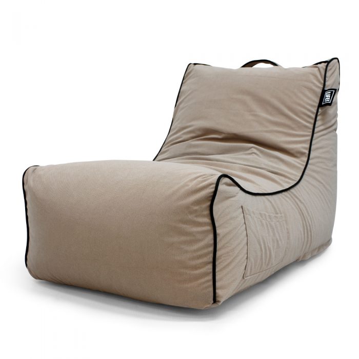 Coastal haven pop lounge in tan velour showing the storage pocket, handle and black contrast trim